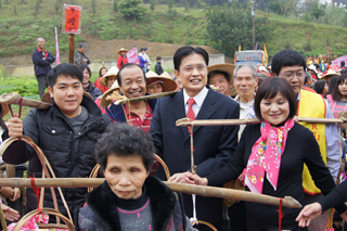 行政院客委會主委黃玉振（圖中）參加新竹縣寶山鄉「打中午暨客家獅傳承推廣活動」，與民眾一同挑擔踩街